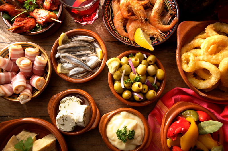 Greek specialities, presented in marble bowls on a wooden table.